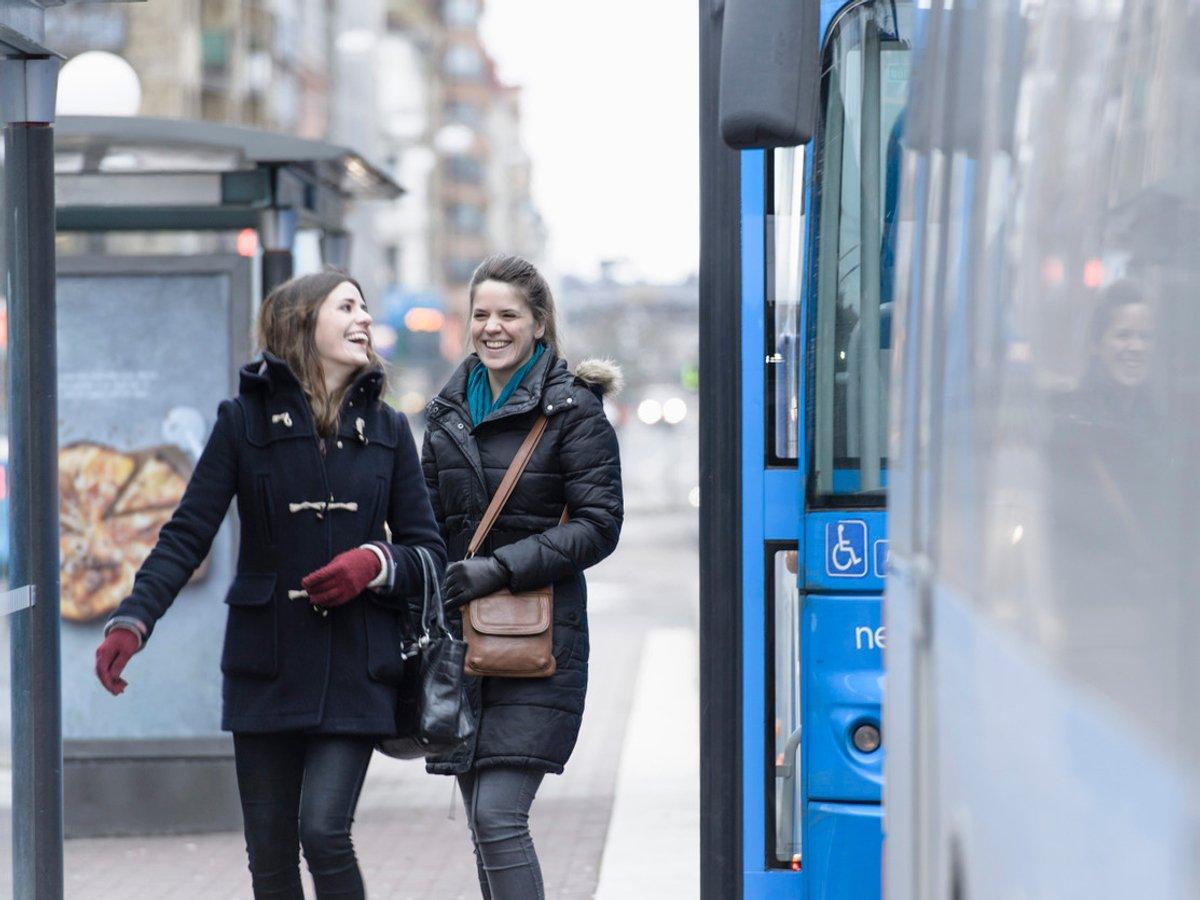 Två kvinnor har gått av bussen med ett leende på läpparna